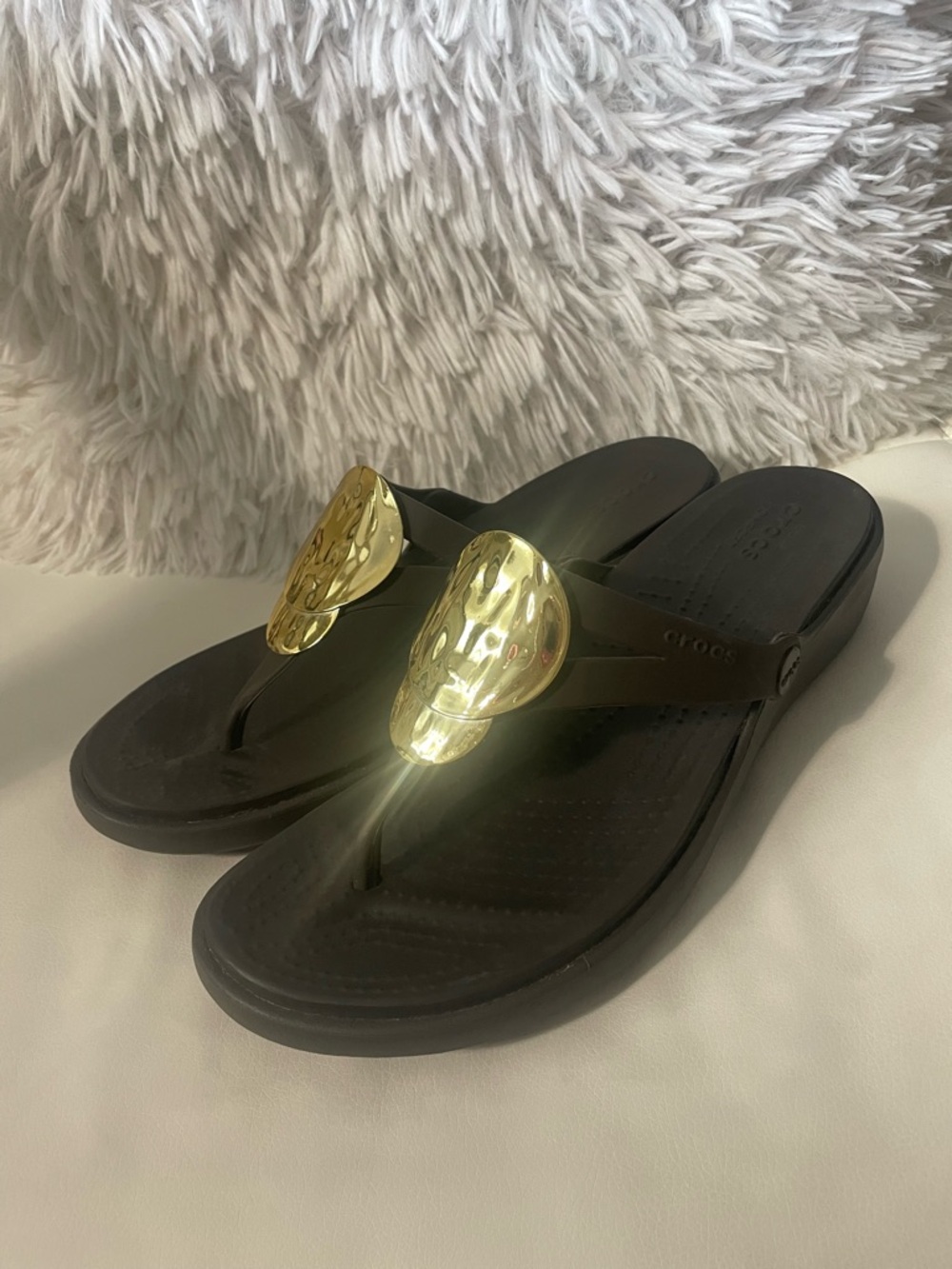 Crocs Black Flip Flop Sandals with Gold Medallion Accent